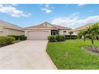 Beautiful one-story home features a lush front lawn and a neutral color palette at 10008 Sugar Mill Dr, Bradenton, FL 34212