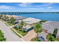 Beautiful home featuring a manicured lawn, a neutral-colored exterior, and a gorgeous waterfront view at 1264 Riverscape St # B, Bradenton, FL 34208