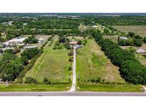 Expansive aerial view of a large lot with green fields, mature trees, and a home nestled in the center at 16305 E State Road 64, Bradenton, FL 34212