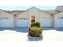 Inviting exterior of the condo featuring attached garages, nicely landscaped grounds, and classic architectural design at 2608 Waterford Way # B, Palmetto, FL 34221