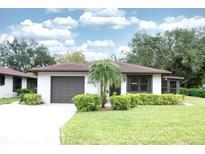 Charming single-story home featuring a well-manicured lawn and mature landscaping at 2614 67Th W St, Bradenton, FL 34209