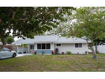 Charming single-story home with well-maintained lawn and mature trees, freshly painted in neutral tones at 2722 Nancy St, Sarasota, FL 34237