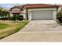 Charming single-story home with a two-car garage and a beautiful terracotta roof at 4729 Peridia E Blvd, Bradenton, FL 34203
