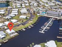 Waterfront home with boat dock offers canal access, golf course, and a community pool at 517 Tampico Dr, North Port, FL 34287