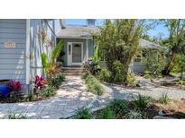 Charming home featuring a lush, landscaped walkway to the front door at 5324 Siesta Ct, Sarasota, FL 34242