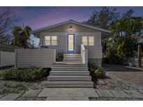 Charming home featuring a welcoming front porch and serene evening ambiance at 652 Ohio Pl, Sarasota, FL 34236