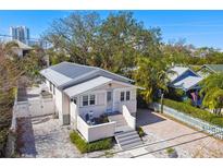 Charming single Gathering home showcasing well-manicured landscaping and a metal roof at 652 Ohio Pl, Sarasota, FL 34236