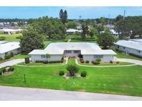 Beautifully landscaped home boasts a well-manicured lawn and charming curb appeal in a serene neighborhood at 7114 11Th W Ave, Bradenton, FL 34209