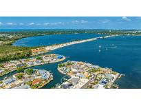 Stunning aerial view of waterfront home with private dock on beautiful blue bay near a beach at 10008 Spoonbill E Rd, Bradenton, FL 34209