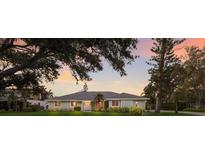 Charming single-story home with lush landscaping, mature trees, and a well-manicured lawn at 1411 70Th Nw St, Bradenton, FL 34209