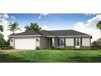 Charming single-story home featuring a manicured lawn, an attached two-car garage, and beautiful landscaping at 21061 Delake Ave, Port Charlotte, FL 33954