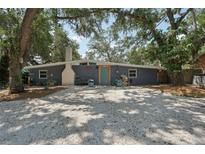 Charming single-story home features a large front yard and eye-catching blue exterior door at 2848 Trinidad St, Sarasota, FL 34231