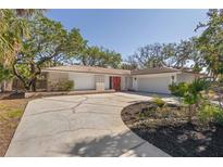 Attractive home featuring a two-car garage, eye catching front doors, and a neatly landscaped yard at 717 Treasure Boat Way, Sarasota, FL 34242