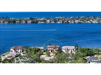 A panoramic aerial view of a waterfront property with lush landscaping and serene blue water views at 7342 Captain Kidd Ave, Sarasota, FL 34231