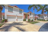 Charming two-story building with a paved driveway, two-car garage, and well-maintained landscaping at 7632 Marsh Orchid Cir # 7632, Bradenton, FL 34203
