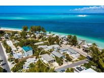 Breathtaking aerial view of beach house community with white sand beaches and stunning ocean views at 811 Jacaranda Rd, Anna Maria, FL 34216