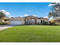 Inviting home with a well-manicured lawn, a two-car garage and an elegant arched entryway at 8314 9Th Avenue Nw Ter, Bradenton, FL 34209