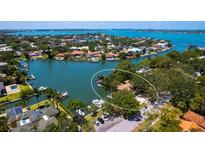 Waterfront property on lush peninsula with boat dock and bay access surrounded by manicured landscaping at 1542 Gulfview Dr, Sarasota, FL 34236