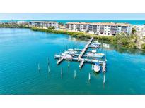 Scenic view of the condo complex private dock with boat slips and beautiful blue water views at 3540 Gulf Of Mexico Drive # 202, Longboat Key, FL 34228