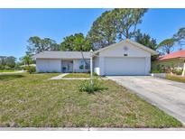 Charming single-story home boasts a two-car garage and a well-maintained front lawn with beautiful curb appeal at 3978 Lemonwood Dr, Sarasota, FL 34232