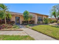 Charming home with mature landscaping, including palm trees and colorful shrubbery, creating curb appeal at 6209 Heritage Ln # 6209, Bradenton, FL 34209