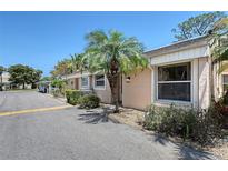 Charming exterior of a home featuring a well-maintained lawn and attractive landscaping, with a clear blue sky overhead at 6240 7Th W Ave # 6240, Bradenton, FL 34209