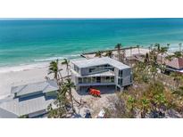Modern beach house showcasing ocean views and contemporary design with floor to ceiling windows at 6603 Gulfside Rd, Longboat Key, FL 34228
