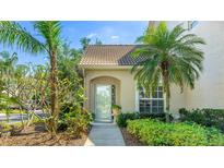 Charming home featuring lush landscaping and a welcoming front entrance with glass door at 6770 Fairway Gardens Dr, Bradenton, FL 34203