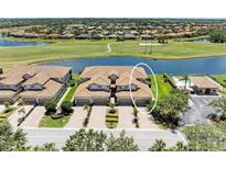 Aerial view of townhomes showing proximity to the golf course and lake at 8304 Grand Estuary Trl # 104, Bradenton, FL 34212