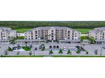 Exterior view of the condominium building with covered parking and manicured landscaping at 17902 Gawthrop Dr # 401, Bradenton, FL 34211