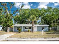 Charming single-story home features a well-maintained front yard with mature trees and a cozy entrance at 1823 8Th E Ave, Bradenton, FL 34208