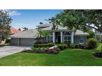 Beautiful single-story home boasts manicured landscaping and a three-car garage at 3738 Eagle Hammock Dr, Sarasota, FL 34240