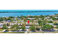 Expansive aerial view of a waterfront community with lush landscaping and tropical surroundings at 519 Bayview Ave, Osprey, FL 34229
