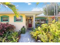 Charming single story home with a landscaped yard and inviting front entrance at 610 Poinsettia Rd, Nokomis, FL 34275