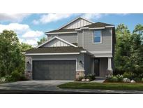 Charming two-story home with a two-car garage, stone accents, and well-manicured landscaping at 8505 Snowfall St, Sarasota, FL 34241
