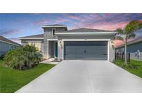 Charming single-story home with a two-car garage, landscaped lawn, and stone facade accents at 11869 Richmond Trl, Parrish, FL 34219
