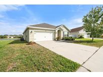Inviting single-story home with a two-car garage and well-maintained lawn on a sunny day at 14914 Flowing Gold Dr, Bradenton, FL 34212