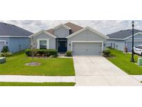 Charming single-story home with a well-manicured lawn and a two-car garage at 16161 61St E Ln, Parrish, FL 34219