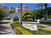 Elegance Condo community entrance with lush landscaping and brick paved drive at 1800 Benjamin Franklin Dr # B310, Sarasota, FL 34236