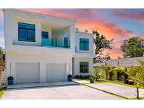 Modern two-story home featuring an attached two-car garage, balcony and minimalist landscaping at 1842 Kenilworth St, Sarasota, FL 34231
