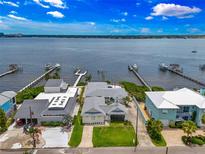 Stunning aerial view of waterfront homes with private docks on a sunny day with lush landscaping at 1907 4Th W St, Palmetto, FL 34221