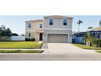 Two-story home showcasing a well-maintained lawn and a convenient two-car garage at 215 63Rd E Dr, Bradenton, FL 34203