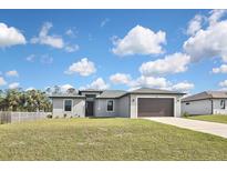 Beautiful single-story home featuring a manicured lawn and attached two-car garage at 3812 Wenona Dr, North Port, FL 34288