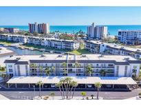 Stunning aerial view of the condo complex with ocean views and boat docks at 4380 Exeter Dr # 304, Longboat Key, FL 34228