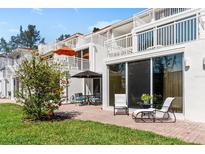 A cozy patio with a lounge chair and outdoor seating invites relaxation in a sunny spot at 5055 Gulf Of Mexico Dr # 414, Longboat Key, FL 34228