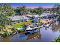 Waterfront home featuring a private boat dock and lift, perfect for enjoying the coastal lifestyle at 5206 18Th E Ave, Bradenton, FL 34208