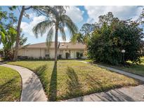 Charming single-story home featuring a well-manicured lawn, mature landscaping, and a welcoming front entrance at 5382 Royal Palm Ave # 5382, Sarasota, FL 34234