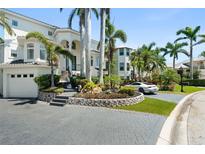 Stunning two-story home with lush landscaping, grey driveway pavers, and a two-car garage at 7118 Hawks Harbor Cir, Bradenton, FL 34207