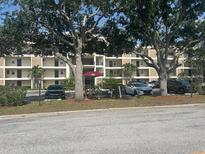 Beautiful apartment complex with mature landscaping and covered parking at 7461 W Country Club N Dr # 201, Sarasota, FL 34243