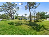 Spacious front yard and exterior of this charming single-story home at 815 31St W Ave, Palmetto, FL 34221